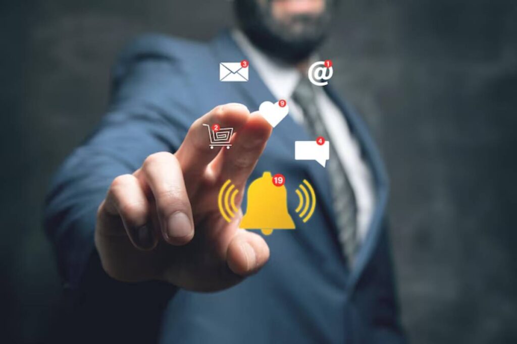 A businessman in a suit interacts with digital notification icons, including messages, alerts, a shopping cart, and a bell.