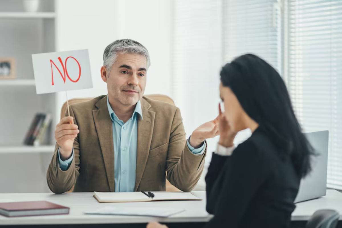 Man holding a No sign during office conversation